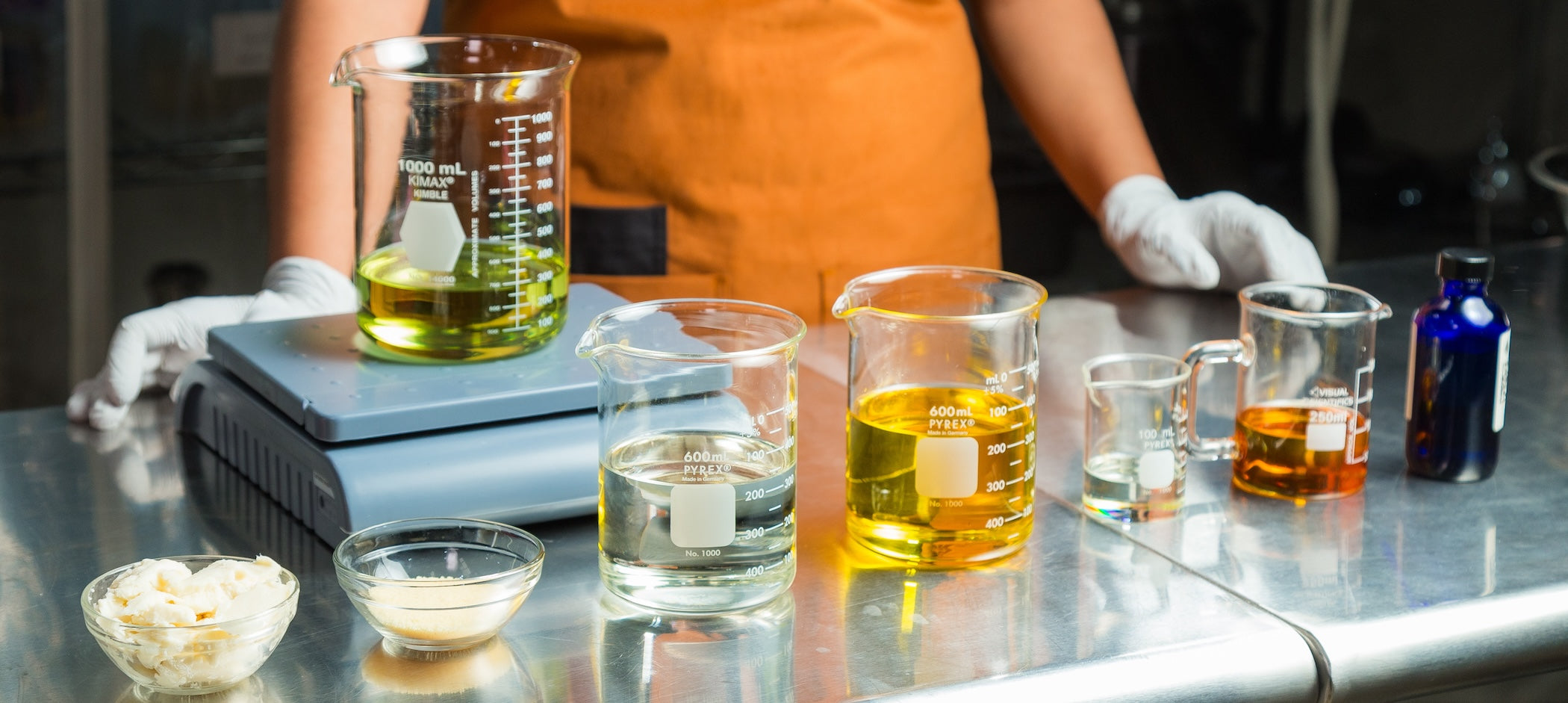 Natural ingredients in beakers for Coffee Scrub product