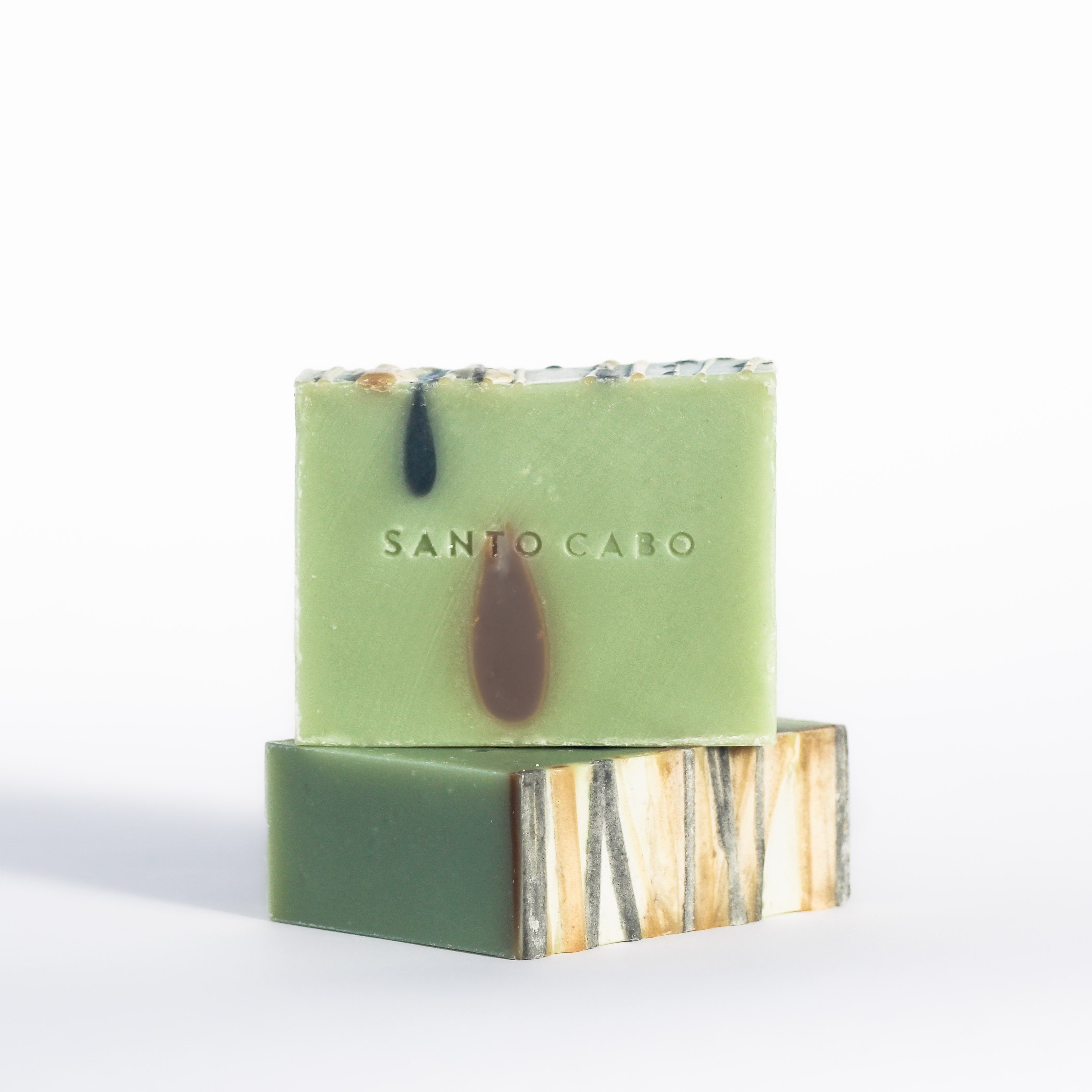 A stack of handmade Avocado Soap with Cocoa and Activated Charcoal.