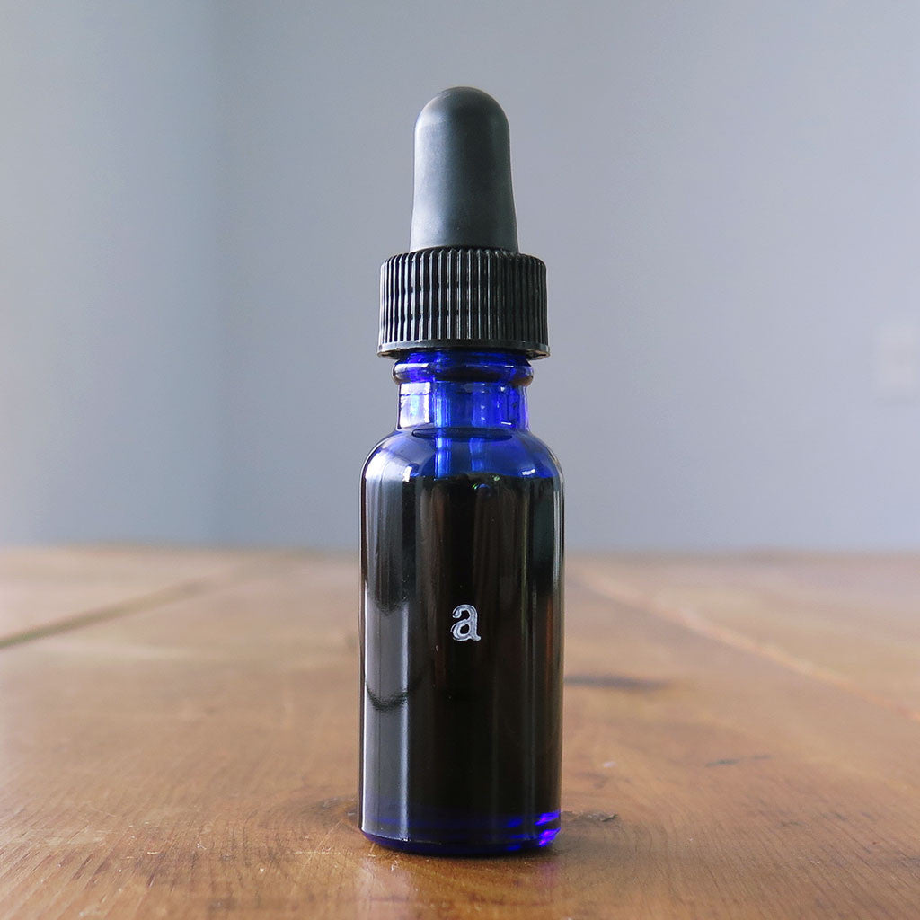 Anti-Age oil serum in a blue 1 oz bottle.